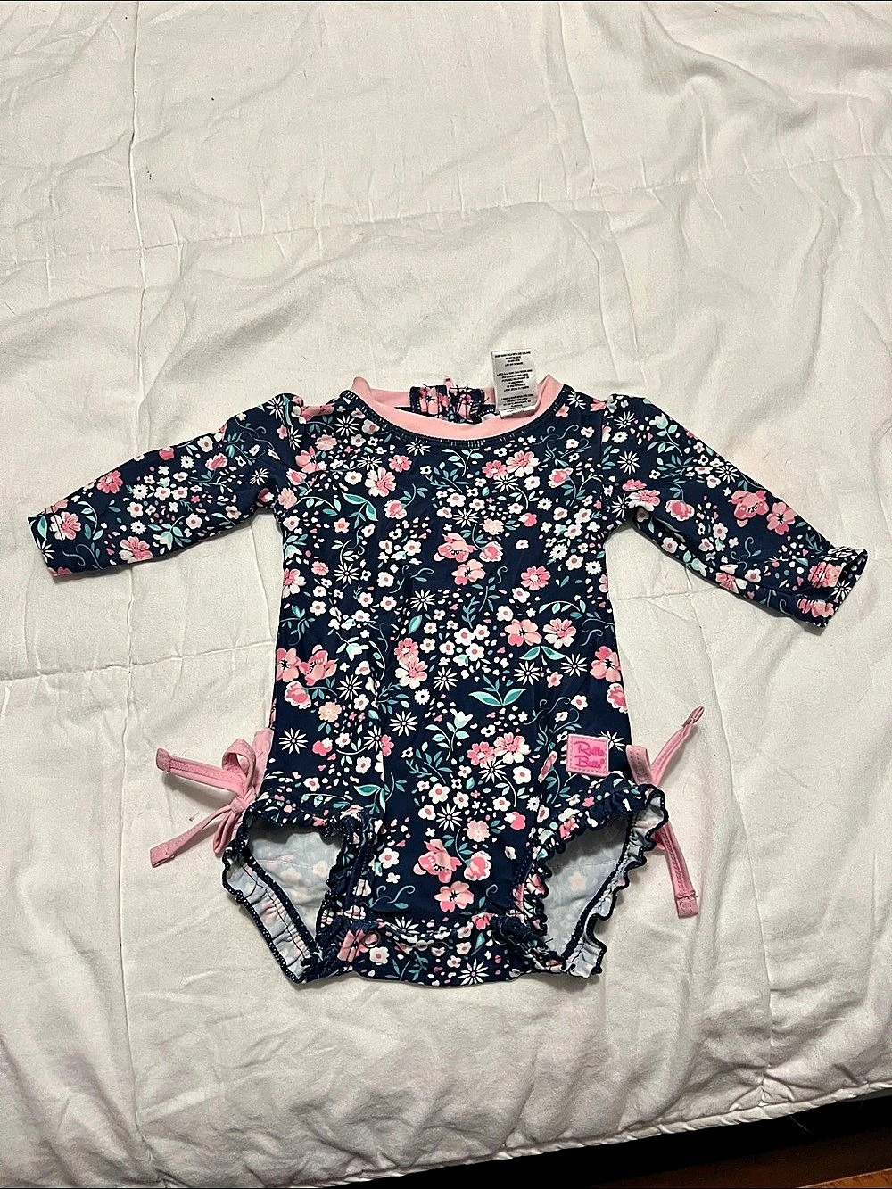 RuffleButts Floral Ruffled One Piece Rash Guard swimsuit in Blue & Pink 0-3M